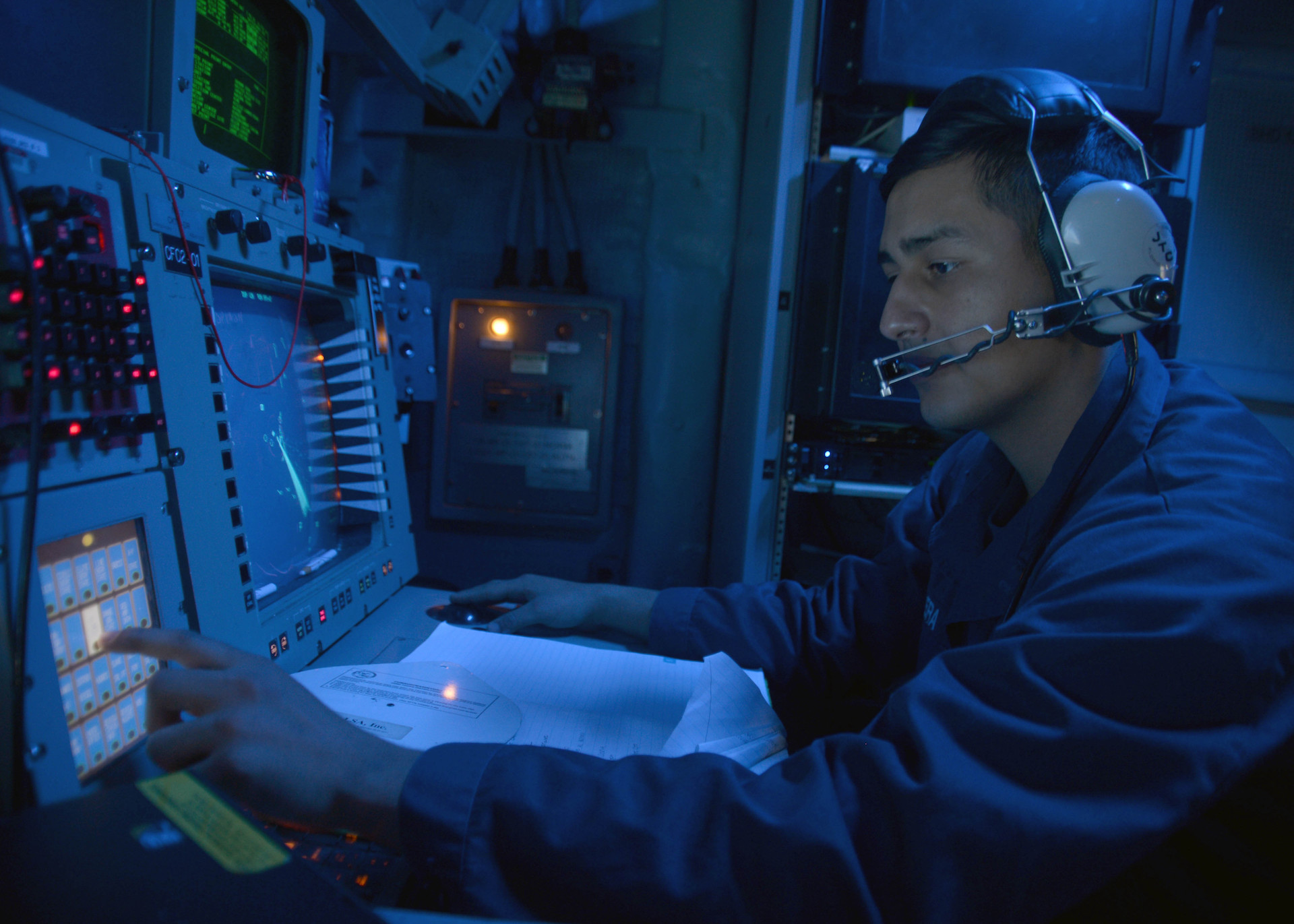 Cryptologic Technician (Technical) 2nd Class David J. Aguilera monitors the electromagnetic spectrum of air and surface contacts in the combat information center aboard the guided-missile destroyer USS Ramage (DDG 61)