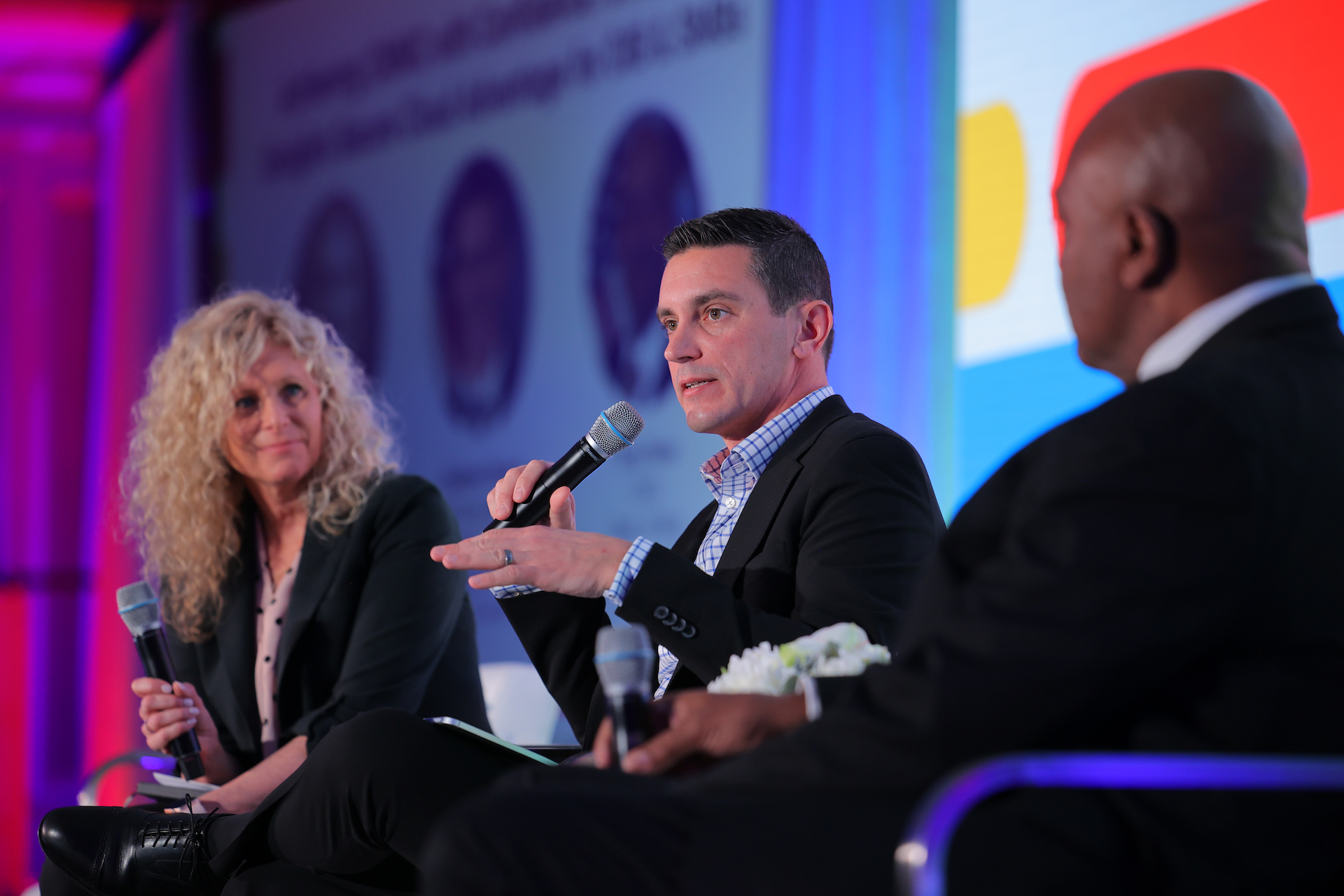 Matthew Picerno (center) and Tony Plater (right) speak on a panel at the Google Defense Forum, moderated by Google's Elizabeth Moon. (DefenseScoop)