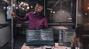 Illustration of engineers discussing software coding. (Getty Images)