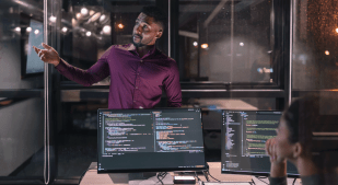 Illustration of engineers discussing software coding. (Getty Images)