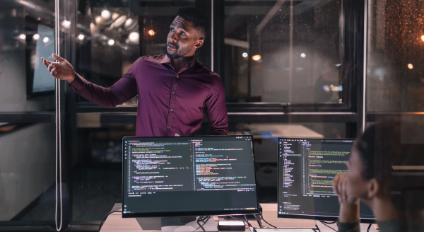 Illustration of engineers discussing software coding. (Getty Images)