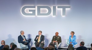 Image of executives speaking on stage at an event.