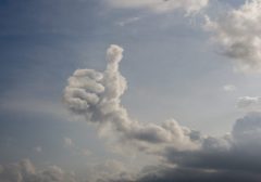 Clouds forming thumbs-up shape in sky